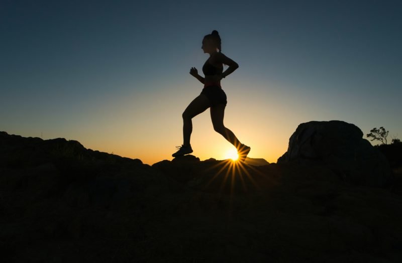 Woman running in sunset